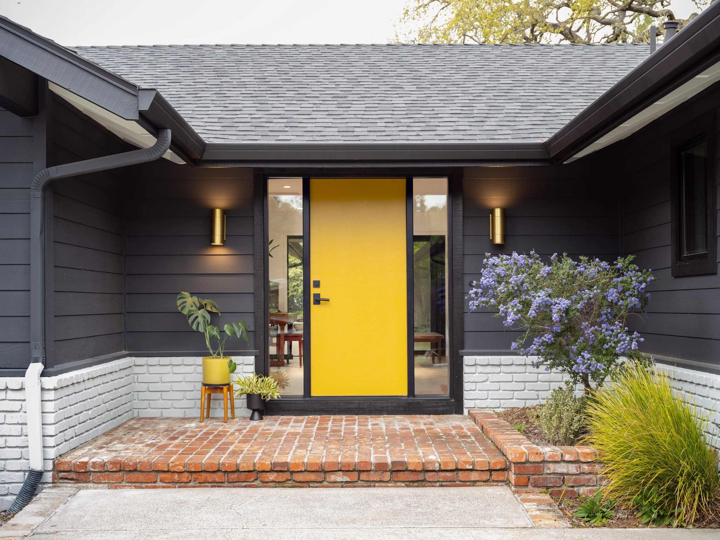House with yellow front door and brick porch