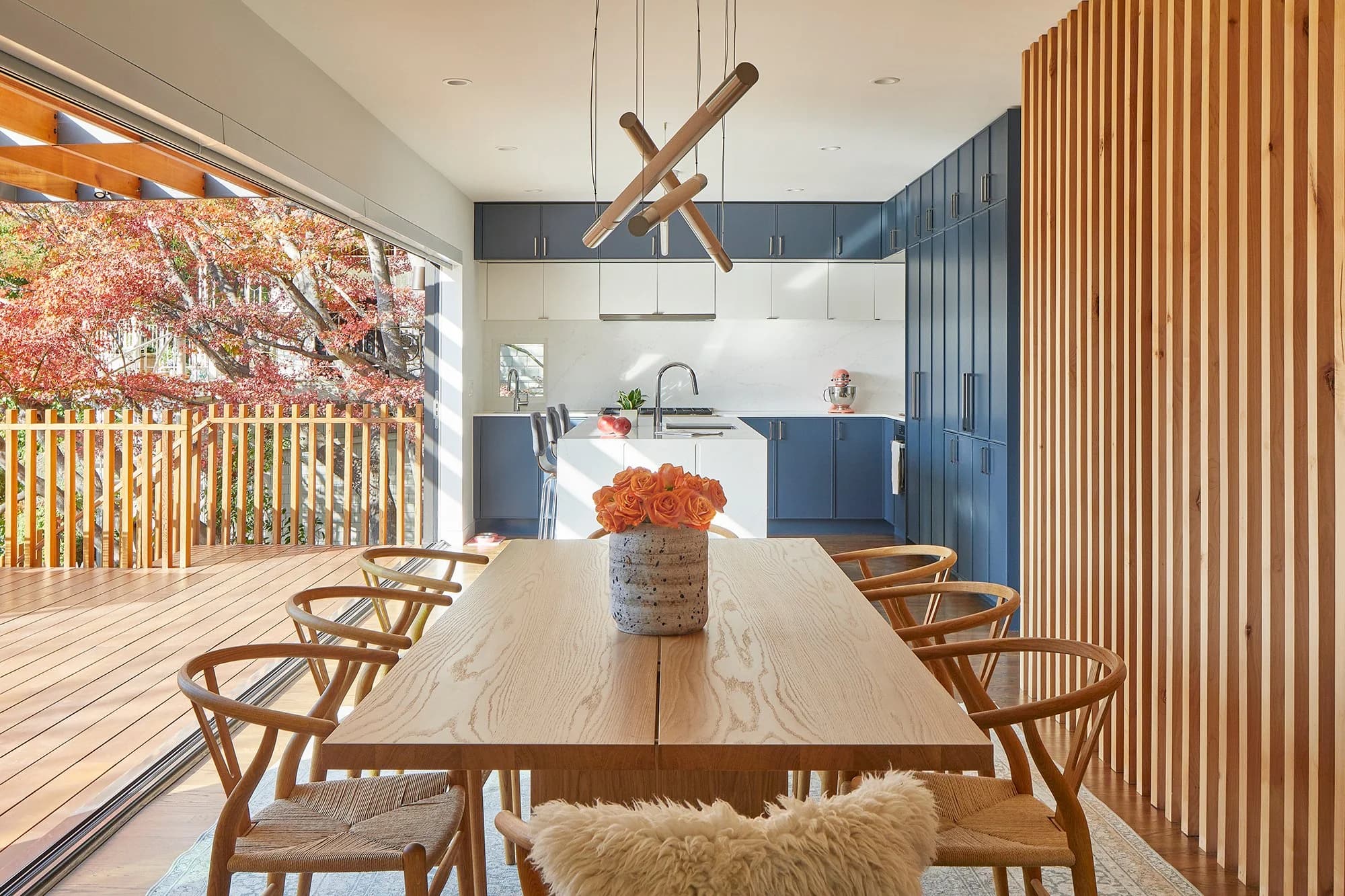 Kitchen with blue cabinets and dining table next to a patio