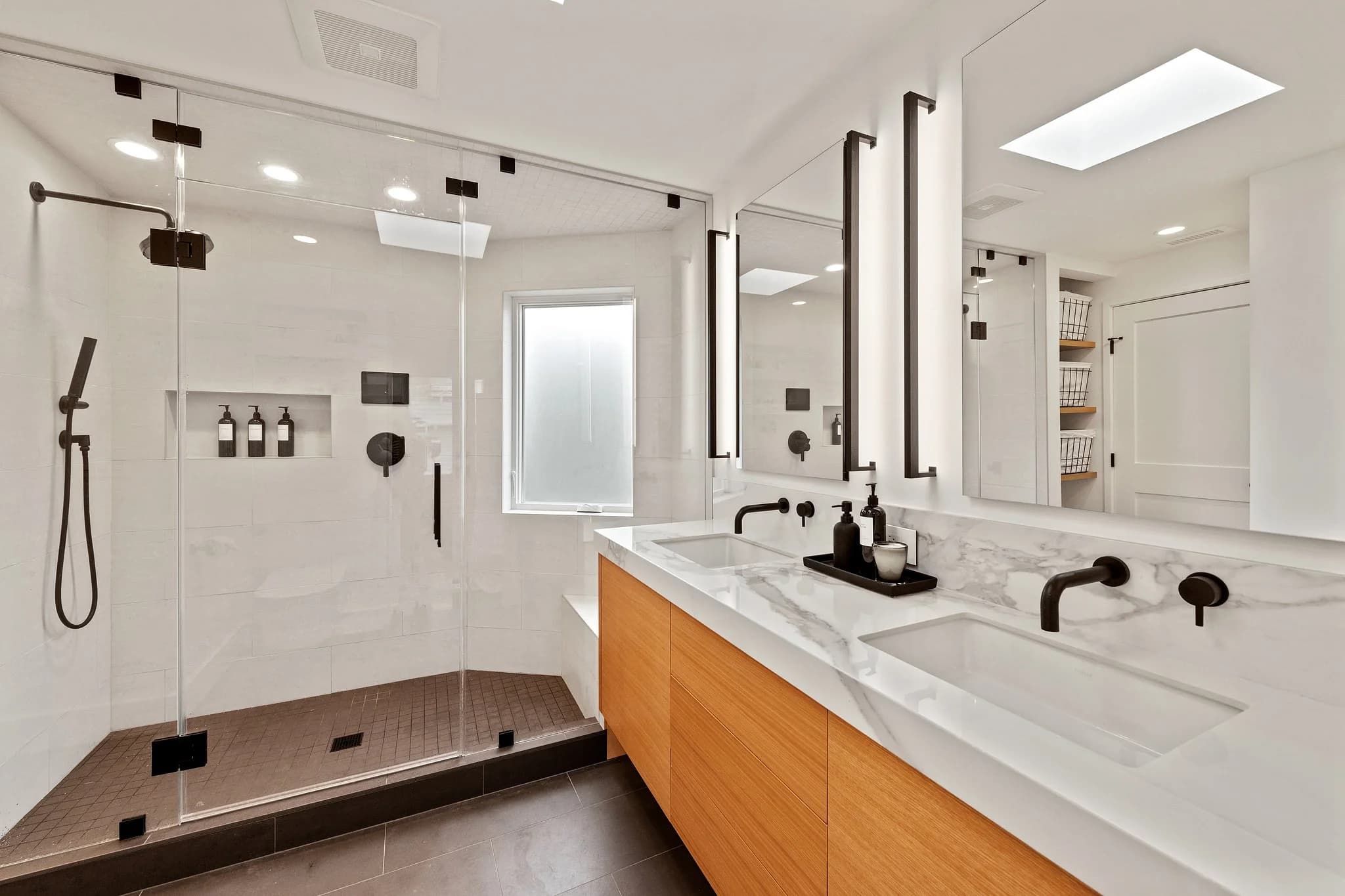 modern bathroom with vanity, mirrors and walk in shower